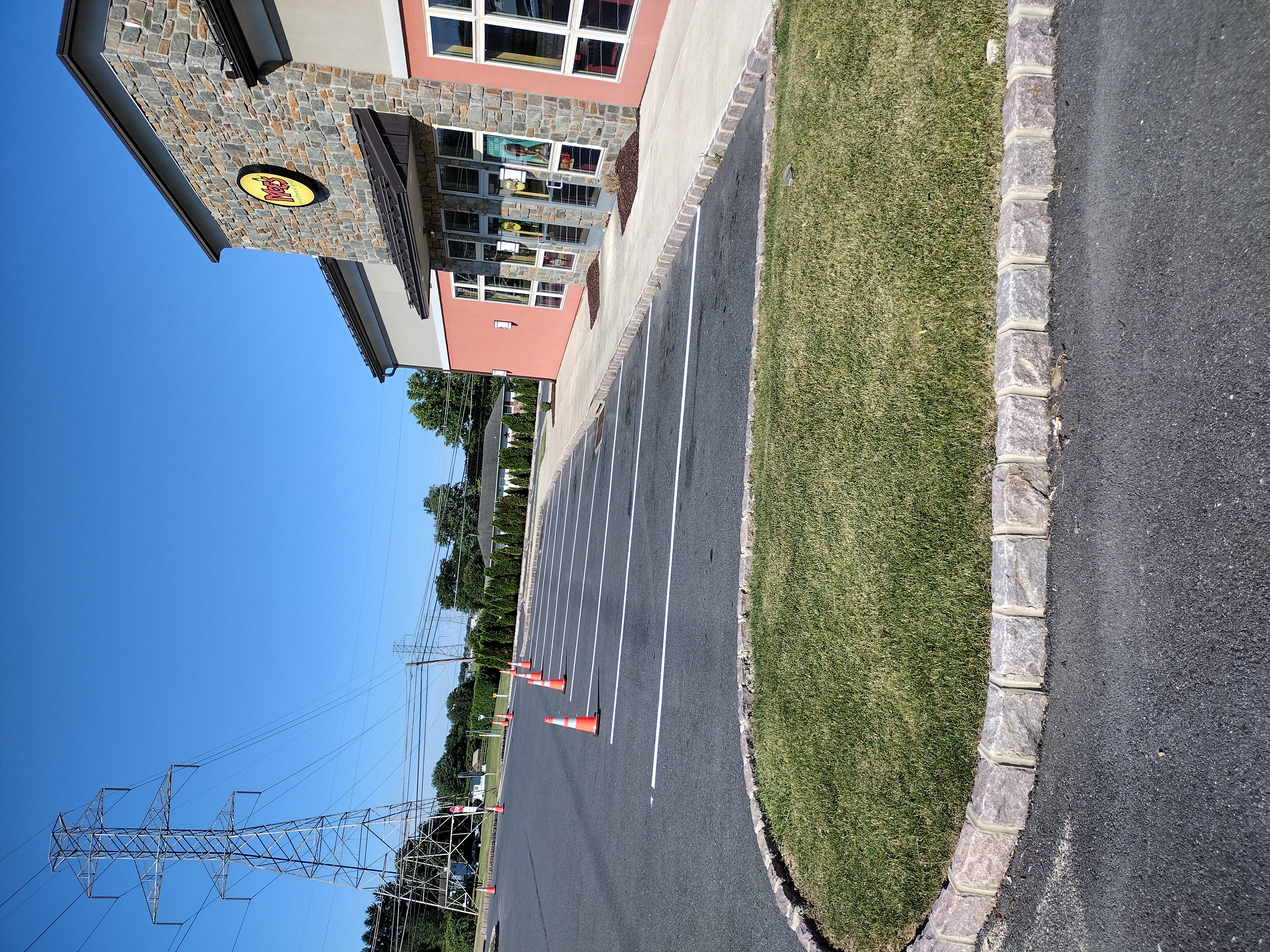 Restriped parking spaces and pavement markings at Moe's